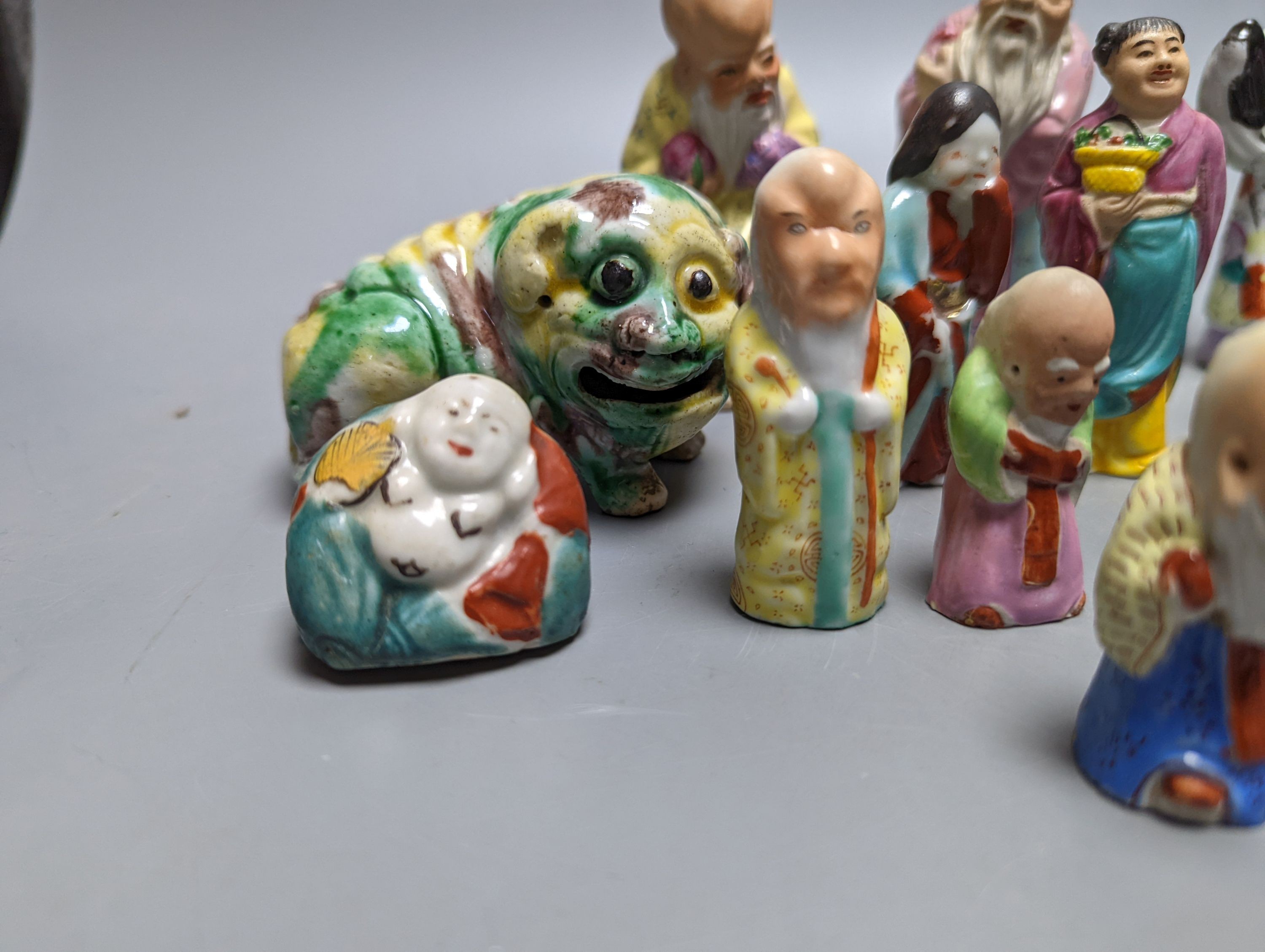 A collection of Chinese enamelled porcelain miniature figurines, including a 19th century Chinese sancai enamelled biscuit figure of a beast, 9cm